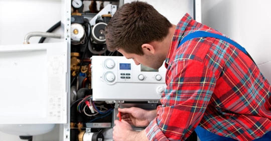 Technician servicing heating boiler