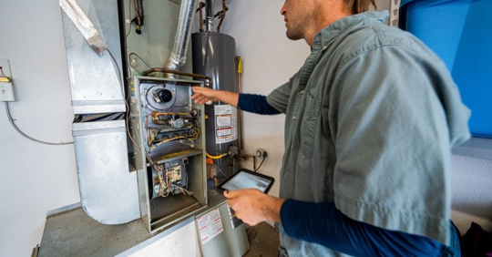 Technician inspecting furnace